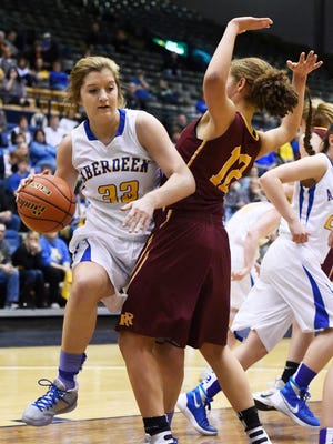 Aberdeen Central's Paiton Burckhard (33) pushes past Roosevelt's Kira Ward (12) with the ball in a state girls class AA basketball quarterfinal March 17.