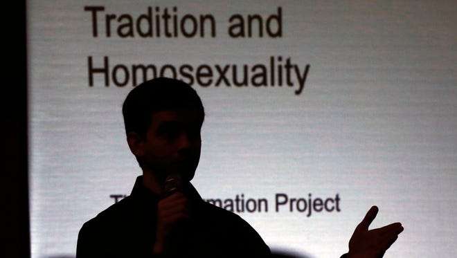 Matthew Vines gives a speech on the Bible and homosexuality at a conference in Prairie Village, Kan., Thursday.