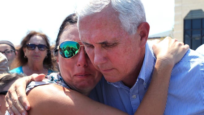 Deidra Cate is comforted by Vice President Mike Pence at the First Baptist Church of Rockport in Rockport, Texas. The Vice-President and several secretaries of state visited Rockport to reaffirm the federal government's promise of help for victims of Hurricane Harvey. Cate said parents are extremely concerned about the state of the schools and want to get them running as soon as possible.