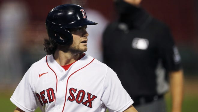 Boston Red Sox outfielder Andrew Benintendi walks back to the dug out after grounding into a double play during the second inning of a baseball game against the Toronto Blue Jays on Saturday in Boston.