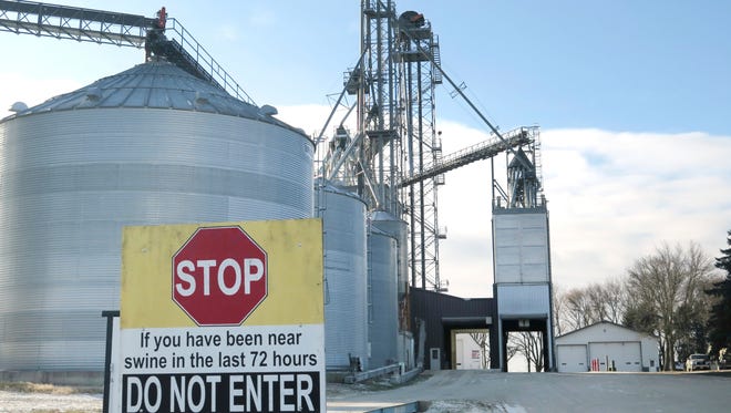 In this Dec. 14, 2016 photo, a sign warns visitors, as disease is a major concern for the Spronk Brothers hog farm near Edgerton in southwest Minnesota. Starting January 1, they and other U.S. livestock producers will have to comply with new federal rules designed to reduce the use of antibiotics in farm animals. (Mark Steil/Minnesota Public Radio via AP)
