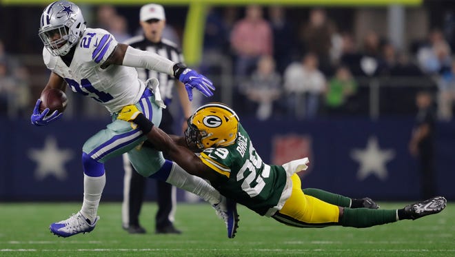 The Cowboys' Ezekiel Elliott fends off Packers safety Kentrell Brice in the second quarter during their NFC divisional playoff game, Jan. 15 n Arlington, Texas.