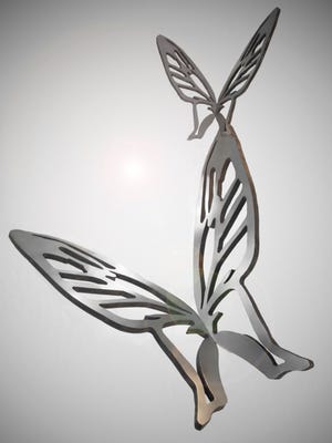 A pair of stainless-steel butterflies that have been installed as a 45-foot sculpture titled "Las Mariposas" at Butterfly Wonderland in Scottsdale.