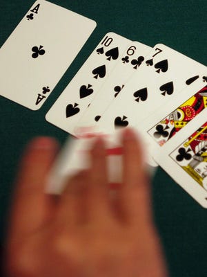 A dealer flips a card during a game at the Commerce Casino in Commerce, Calif. (Wally Skalij/Los Angeles Times/TNS)