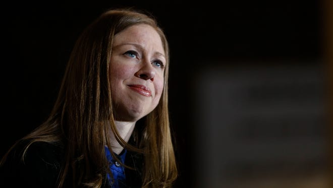 Chelsea Clinton looks on as President Bill Clinton speaks Saturday Jan. 16, 2016 as they rally supporters for Democratic presidential candidate Hillary Clinton at Lincoln High School in Des Moines.