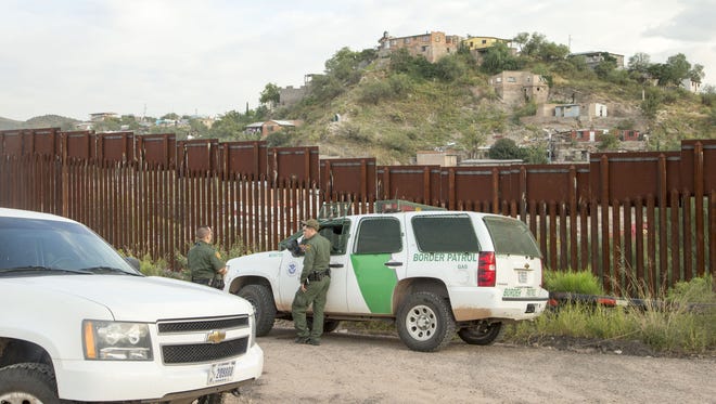 U.S. Border Patrol agents patrol the border fence in Nogales, Arizona.
