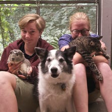 Sisters Linnea Finkle, left, and Freya Finkle of Poughkeepsie cuddle their family pets, guinea pig, Albus Percival Wulfric Brian Dumbledore; cat, Echo, and dog, Skjoa.