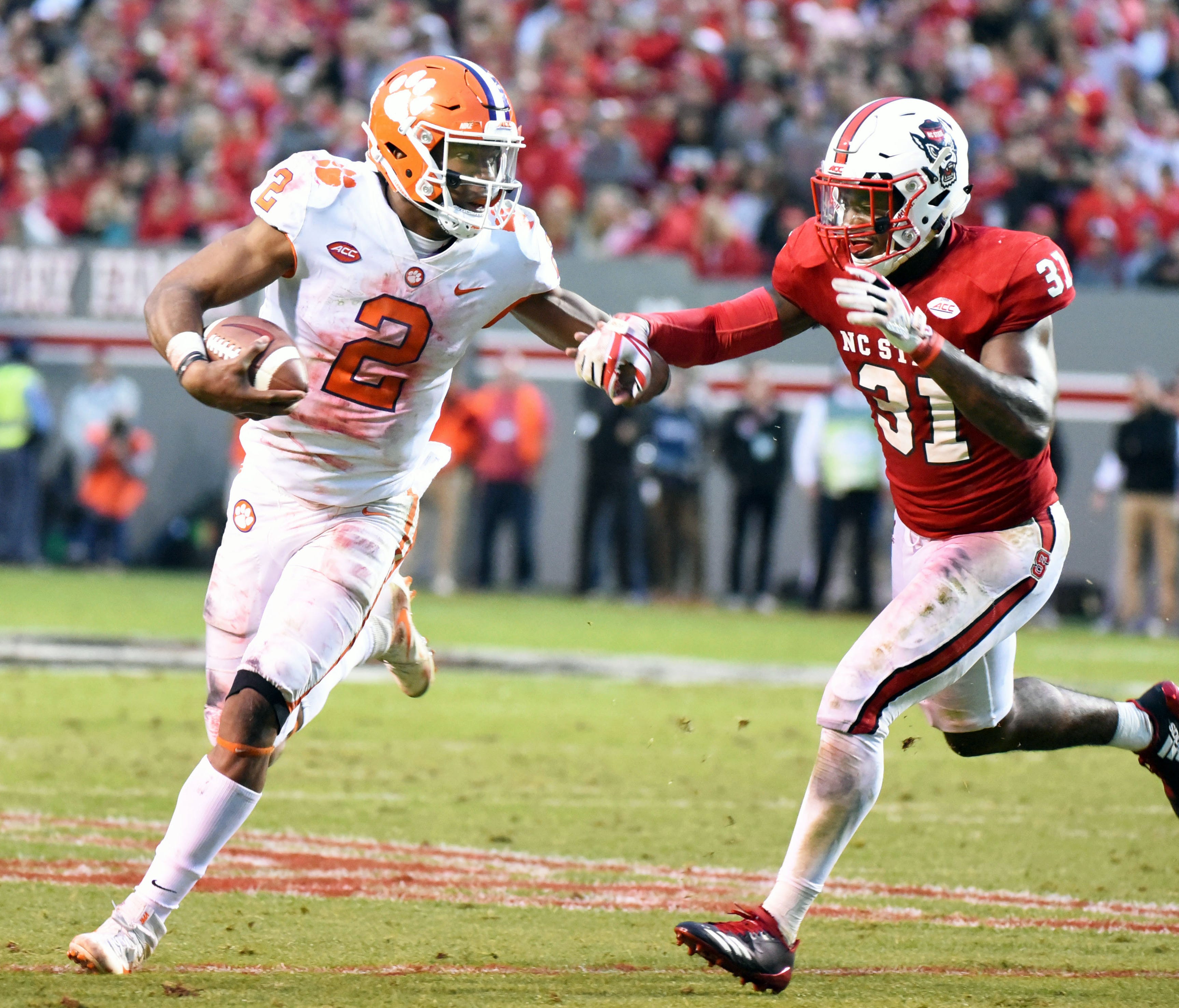 Clemson quarterback Kelly Bryant (2) tries to run away from North Carolina State defensive back Jarious Morehead.