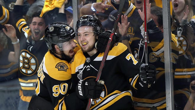 Boston Bruins' Charlie McAvoy, right, celebrates his goal against the St. Louis Blues with Marcus Johansson, left, during the second period in Game 1 of the Stanley Cup Final Monday. Boston won 4-2.