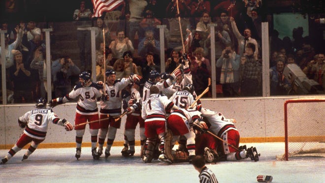 In this Feb. 22, 1980 file photo, the U.S. hockey team pounces on goalie Jim Craig after a 4-3 victory against the Soviets in the 1980 Olympics, as a flag waves from the partisan Lake Placid, N.Y. crowd. It’s been more than three decades since his landmark goal became the centerpiece of the U.S. Olympic hockey team’s Miracle on Ice. For 60-year-old Mike Eruzione, it still seems like only yesterday.