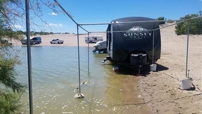 A Sunset camper trailer sits half in the lake at Elephant Butte Tuesday.