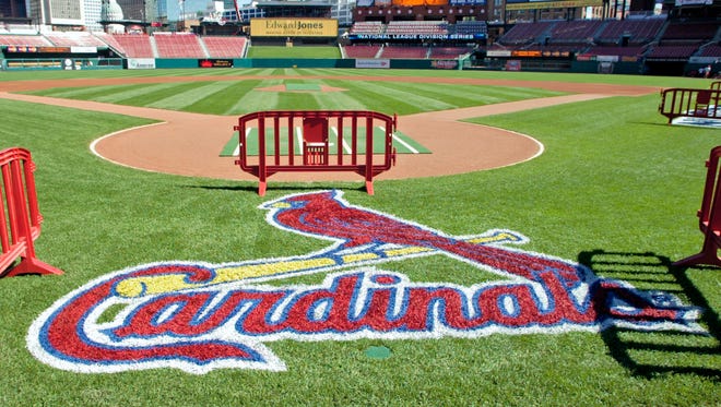 In this Oct. 6, 2006 file photo, a freshly painted St. Louis Cardinals logo adorns the grass behind home plate at Busch Stadium in St. Louis.