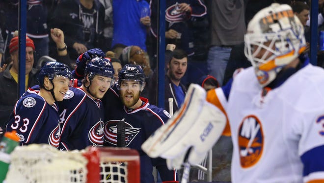 Columbus Blue Jackets right wing Josh Anderson (middle) celebrates scoring a goal with teammates left wing Markus Hannikainen (33) and defenseman David Savard (58) against the New York Islanders.