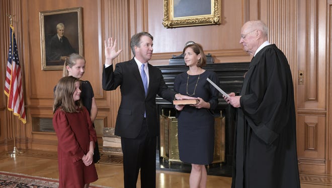 Justice Anthony M. Kennedy, (Retired) administers the Judicial Oath to Judge Brett M. Kavanaugh in the Justices Conference Room, Supreme Court Building. Mrs. Ashley Kavanaugh holds the Bible, Oct. 6, 2018.