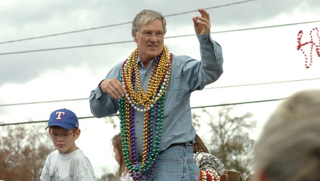 Former Ball Mayor Roy Hebron throws out beads during the 2010 Ball Christmas Parade.
