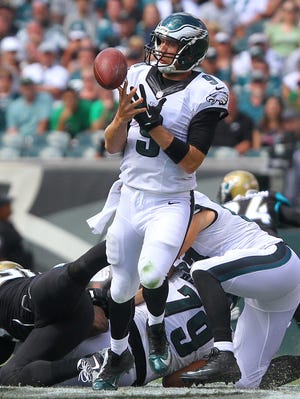 Nick Foles bobbles the ball after he was hit in the backfield on Sunday.