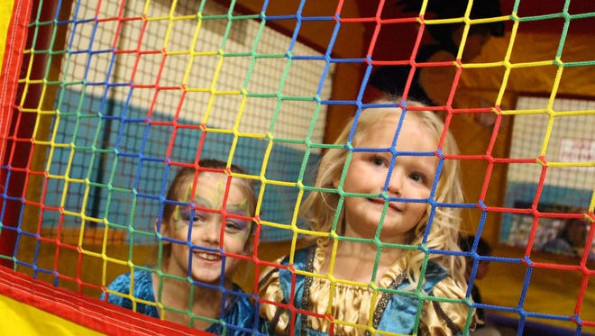  The Bowling sisters, Laila, 8, and Evie, 5, jumped their hearts out in the inflatable bounce house at the carnival.