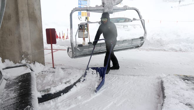 An employee clears snow at Northstar California Resort on Thursday, March 22, 2018.
