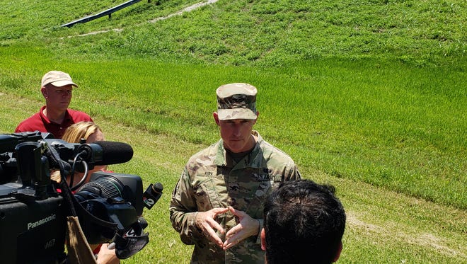 Col. Jason Kirk of the Army Corps of Engineers Jacksonville District answers questions Thursday during a press conference at the base of the Herbert Hoover Dike at John Stretch Park near Clewiston.