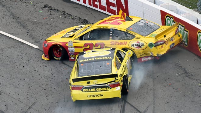 Matt Kenseth (20) plows into Joey Logano (22) and drives him into the wall in the Chase for the Sprint Cup race at Martinsville Speedway.
