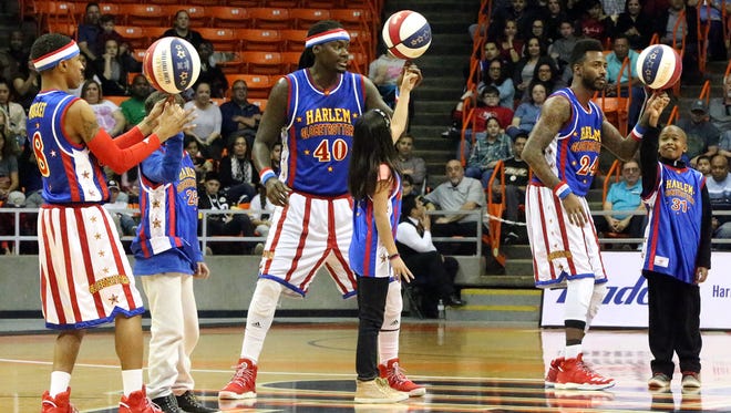 Slick Willie Shaw, 40, and fellow Harlem Globetrotters Rocket Pennington, 8, and Dragon Taylor, 24, help three kids spin balls on their fingers in the middle of their game in January with the All Stars team in the Don Haskins Center. The famed wizards of basketball stopped by as part of their 2017 World Tour. The team, founded in 1926, has entertained more than 144 million fans in 122 countries and territories, their website states.