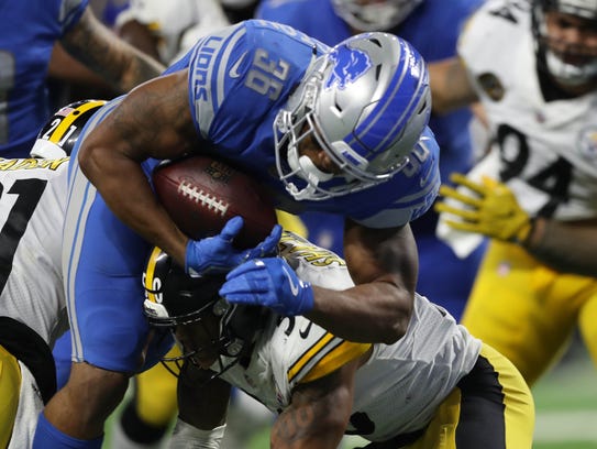 Dwayne Washington is stopped at the goal line by Steelers defenders during the third quarter.