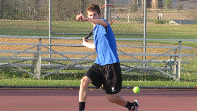 Millbrook High School boys tennis player Daniel Feigelson takes a swing on the court.