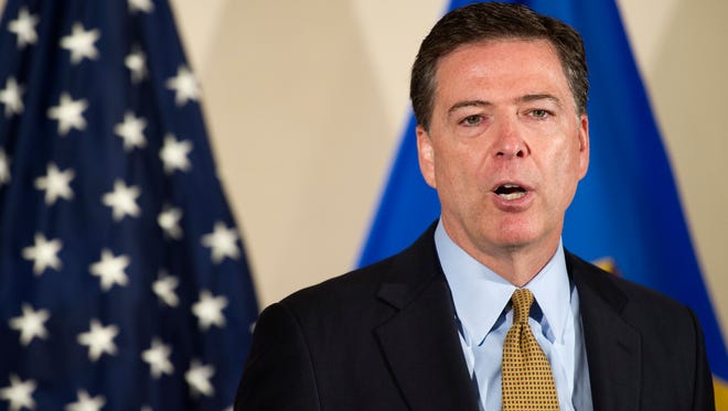 FBI Director James Comey makes a statement at FBI Headquarters in Washington on Tuesday. Comey said the FBI will not recommend criminal charges in its investigation into Hillary Clinton's use of a private email server while secretary of state.