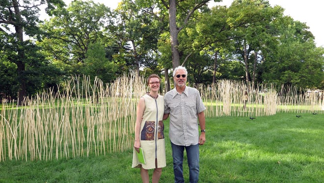 Curator Pamela Caserta Hugdahl and artist Thomas Ferrella stand near his environmental sculpture at UWM.