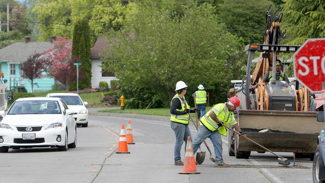Work begins on the Lebo Blvd project in East Bremerton. Workers patch the road across from Lions Park on Friday.