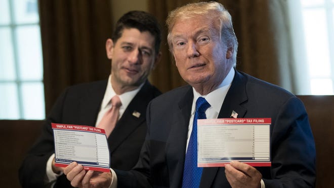 House Speaker Paul Ryan and President Trump on Nov. 2, 2017, show what tax forms could look like.