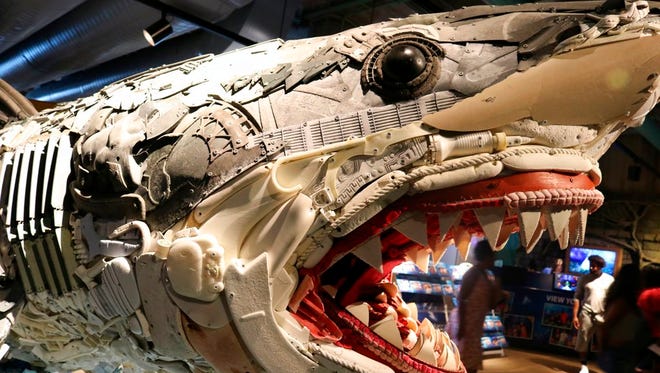 In this photo taken July 26, 2018, the front third of "Greta the Great White Shark," one of six huge sea-life sculptures from a project called Washed Ashore: Art to Save the Sea, is viewed at the Audubon Aquarium of the Americas in New Orleans.