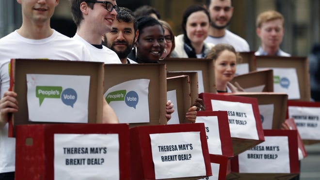 Activists from the People's Vote campaign show 'Deal or No Deal' boxes in London, Jan. 14, 2019. Britain's Prime Minister Theresa May is struggling to win support for her Brexit deal in Parliament.