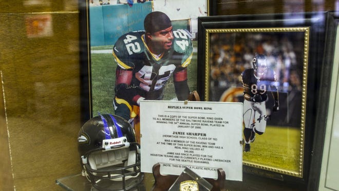 Officials at Hermitage High School in Henrico, Va., removed all Darren Sharper memorabilia from the school's trophy case after the former Hermitage star pleaded guilty this week to date rapes of several women in multiple states.