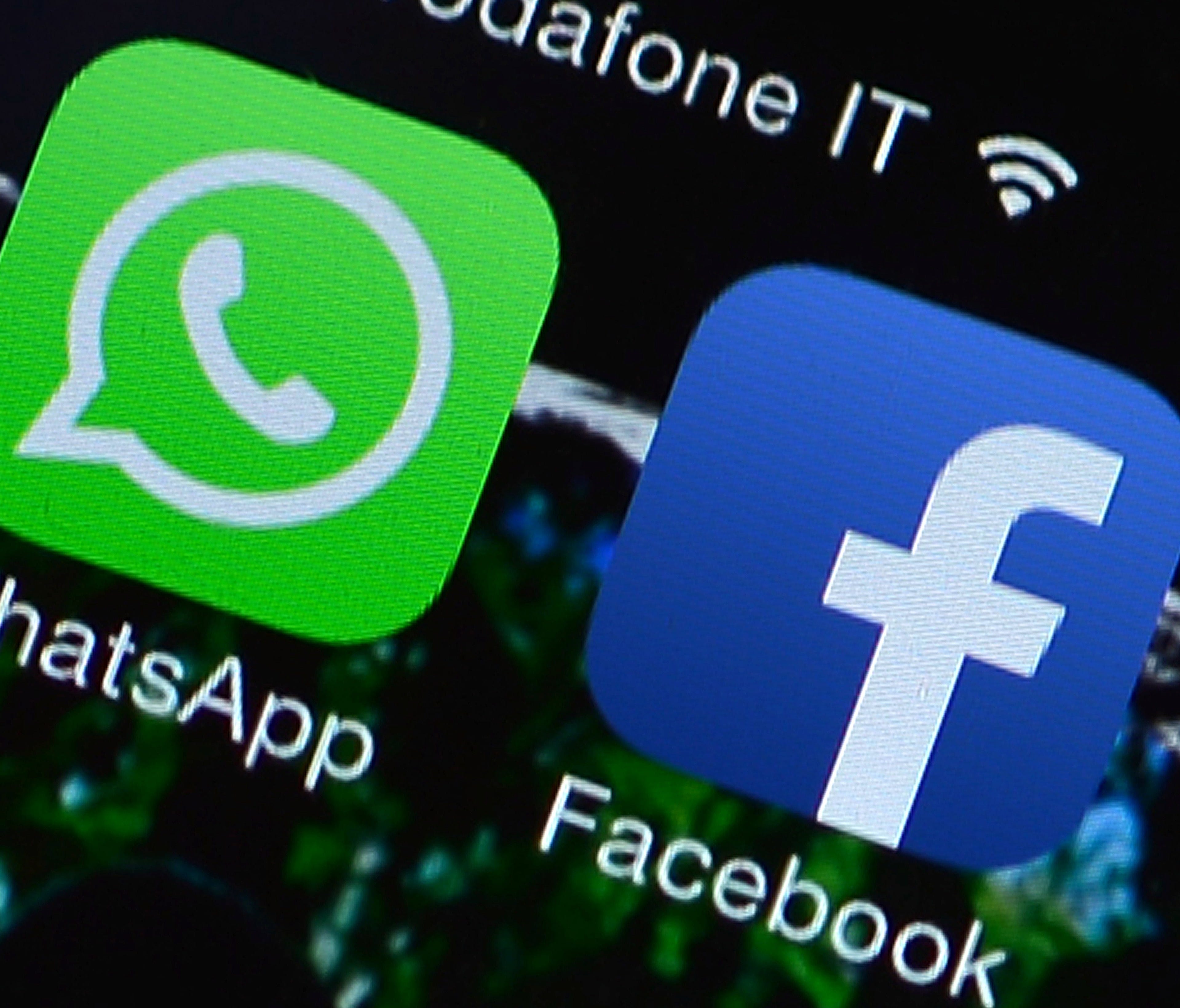 This file picture taken on Feb. 20, 2014 in Rome shows the Facebook and WhatsApp applications' icons displayed on a smartphone.