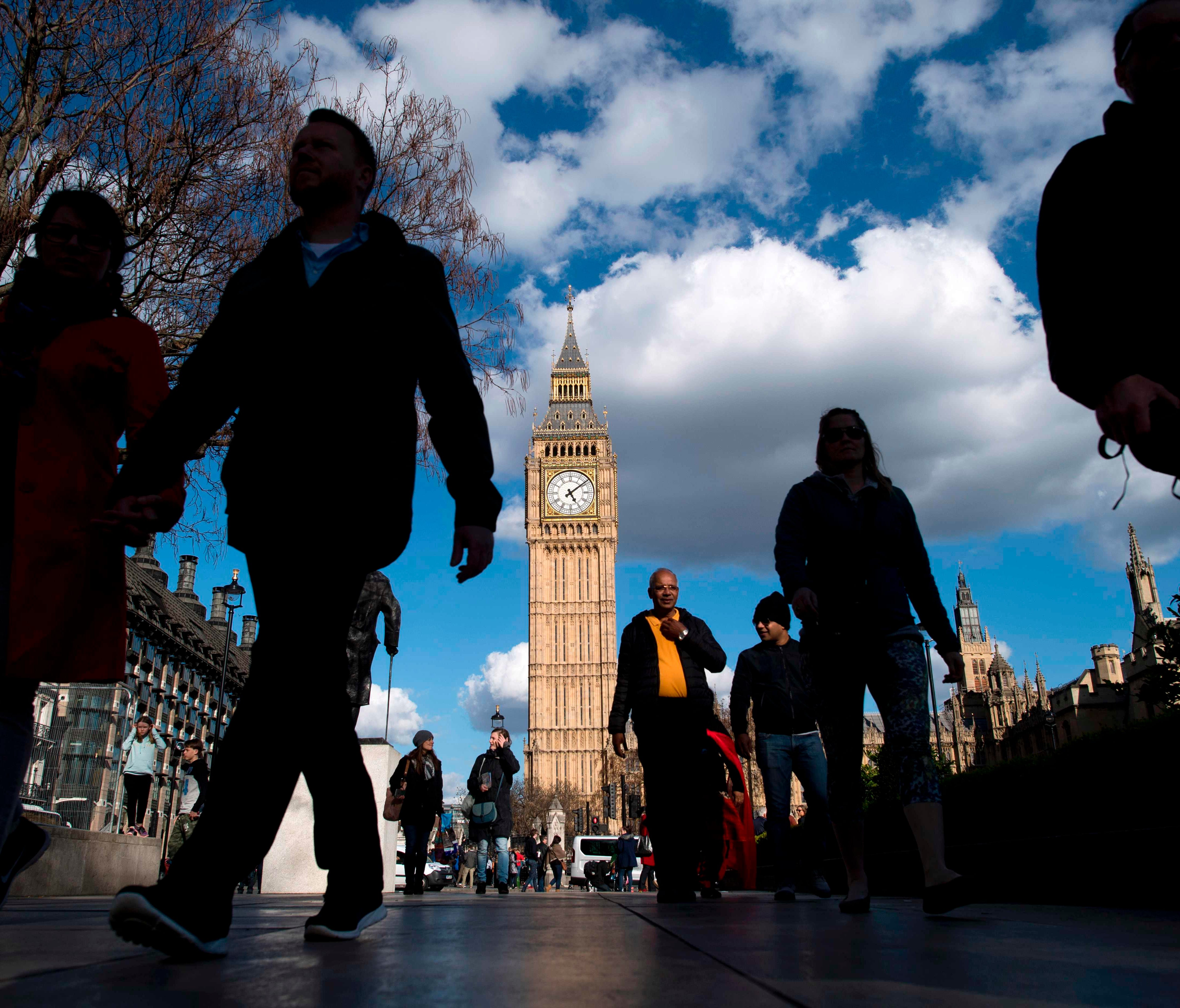 People walk near the Elizabeth Tower, commonly referred to as Big Ben, near the Houses of Parliament in Westminster, central London.  British Prime Minister Theresa May called for a snap election on June 8, in a shock move as she seeks to bolster her 