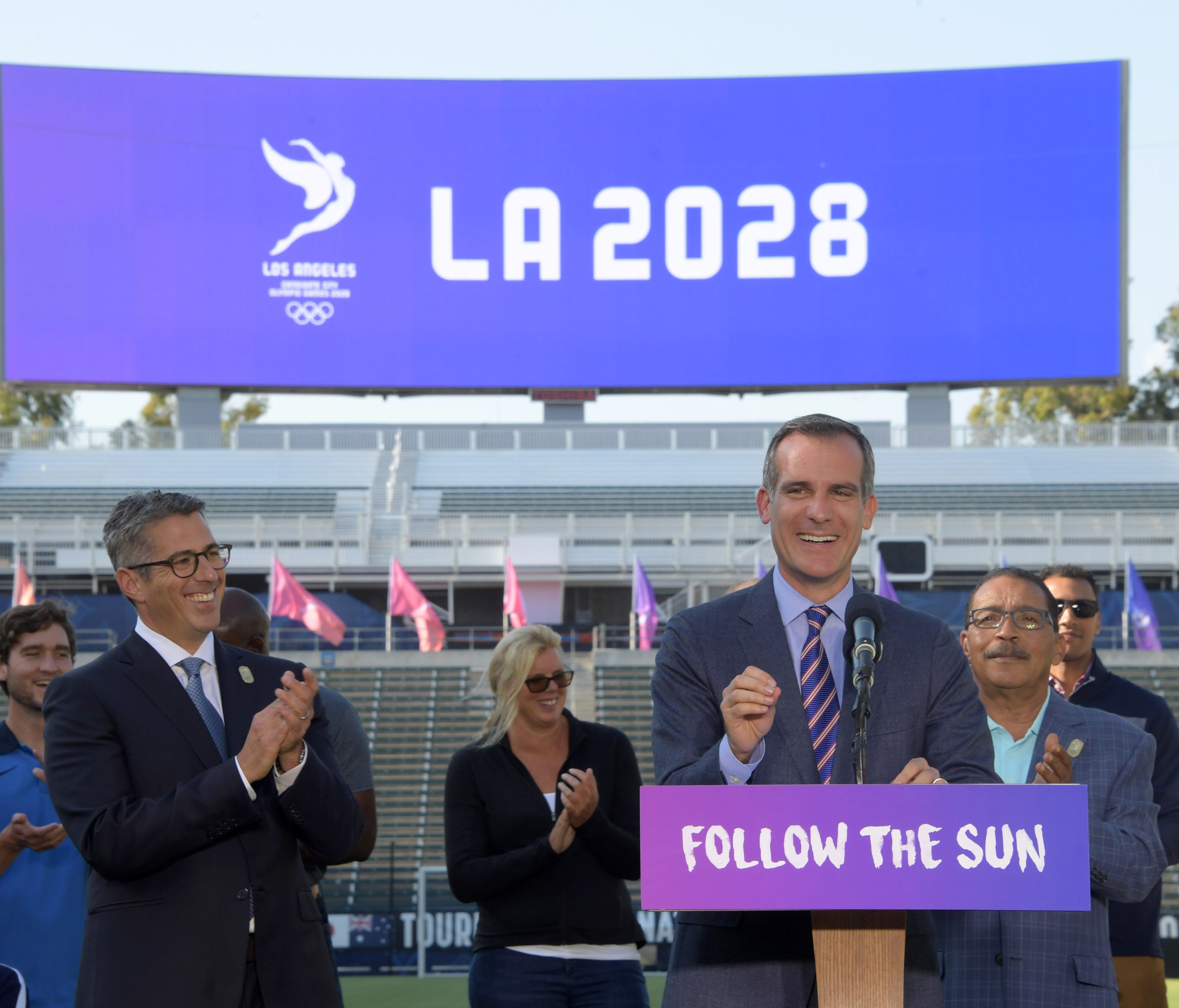 Los Angeles mayor Eric Garcetti speaks as LA2024 bid chairman Casey Wasserman applauds at left during a news conference Monday at StubHub Center.