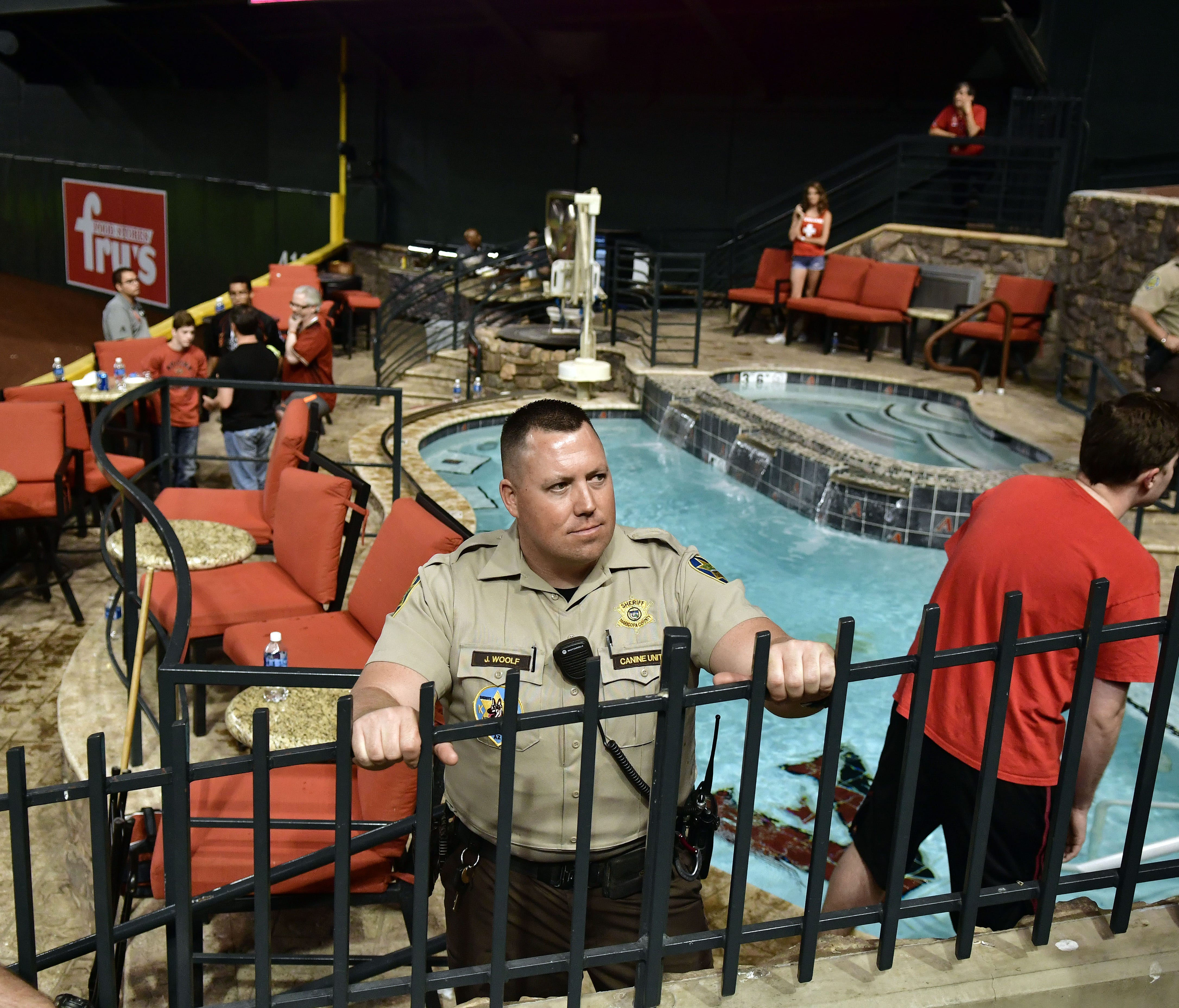 Police and venue security guard the pool area following the Dodgers victory.