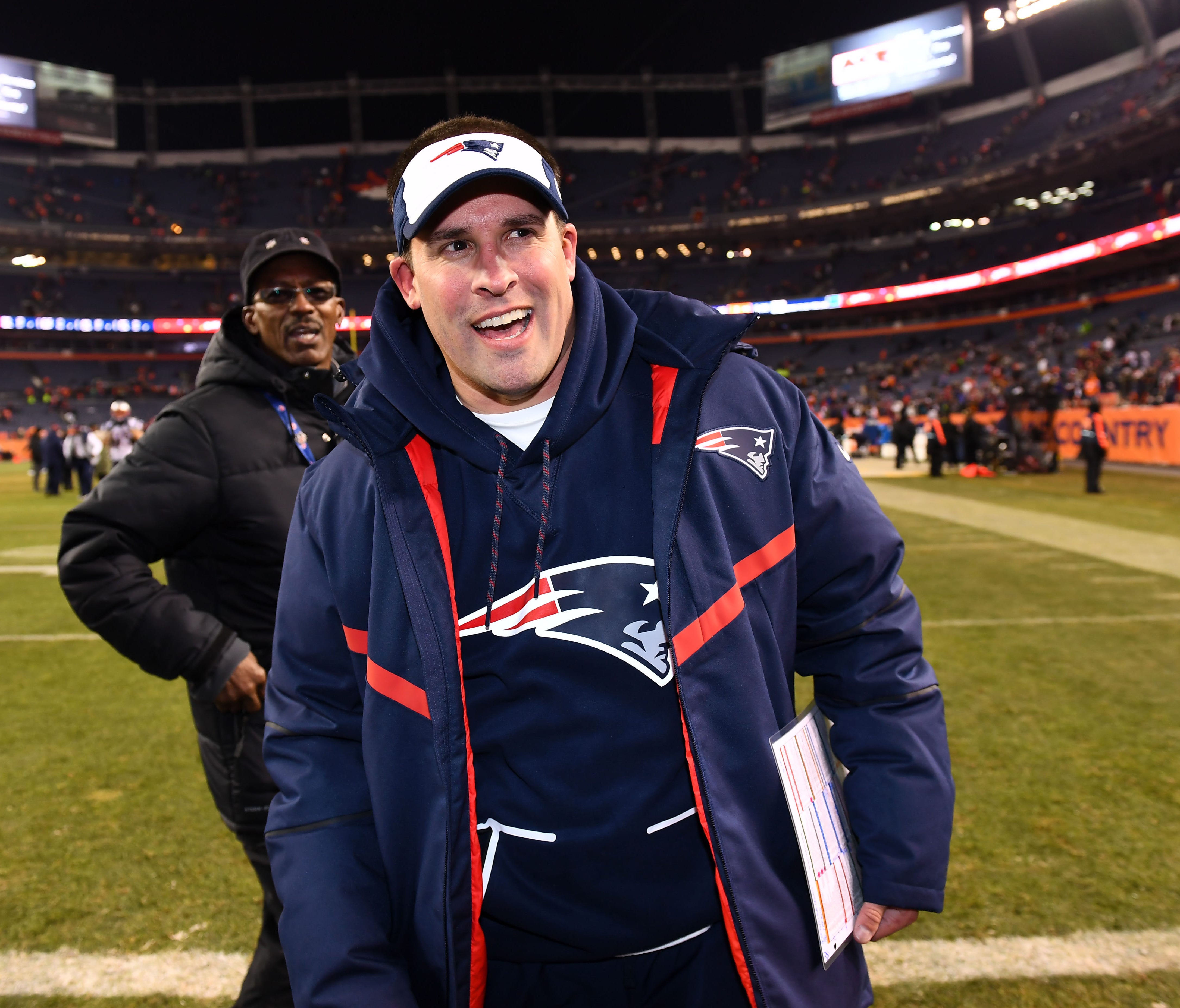 New England Patriots offensive coordinator Josh McDaniels reacts as he leaves the field following the win against the Denver Broncos at Sports Authority Field.
