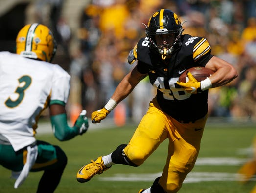 Iowa wide receiver George Kittle runs the ball against