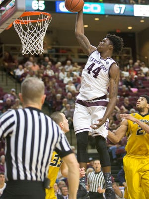 Texas A&M forward Robert Williams (44) dunks over Missouri guard Cullen VanLeer (33) during an NCAA college basketball game Wednesday, Feb. 8, 2017, in College Station, Texas. (Timothy Hurst/College Station Eagle via AP)