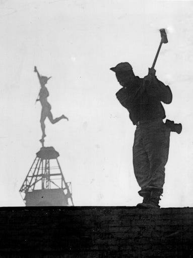 In this 1951 photo, an employee of a wrecking firm