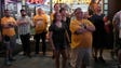 Fans stand in front of Music City Souvenirs on  Lower