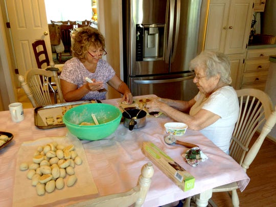 Judy Warner and her mother, Palma Lenza, preparing cookies