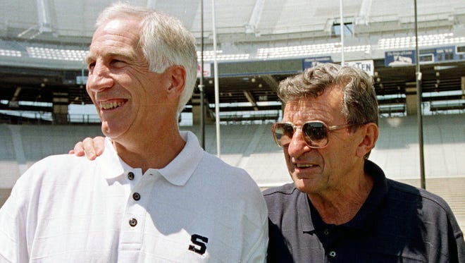 FILE - In this Aug. 6, 1999, file photo, Penn State football coach Joe Paterno, right, poses with his defensive coordinator, Jerry Sandusky, during the college football team's media day in State College.
