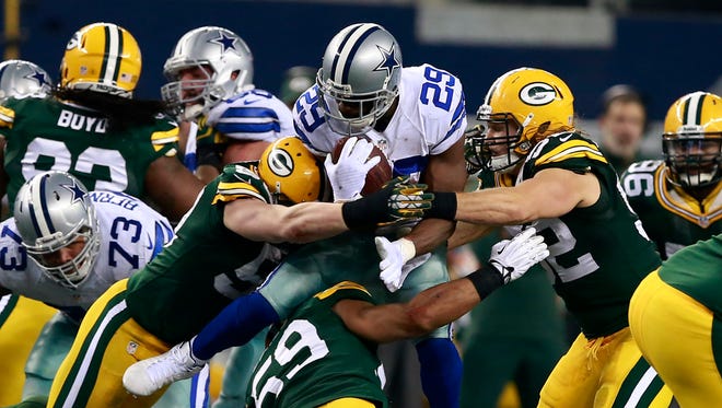 Cowboys running back DeMarco Murray is tackled by Packers linebackers A.J. Hawk, Clay Matthews and Brad Jones during the second half of last year's game.