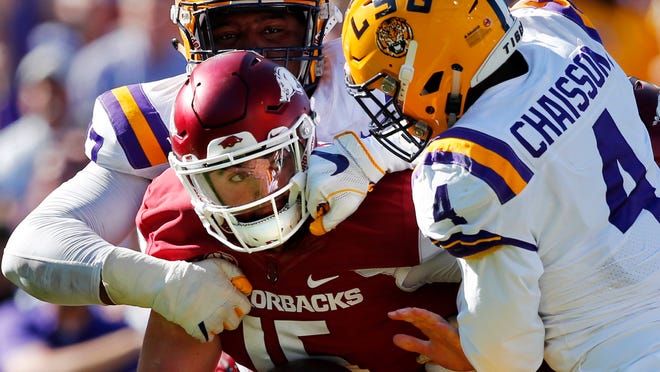 Arkansas quarterback Cole Kelley is stopped short on fourth down by LSU linebacker K'Lavon Chaisson (4) and defensive end Frank Herron in the second half of an NCAA college football game in Baton Rouge, La., Saturday, Nov. 11, 2017. LSU won 33-10. (AP Photo/Gerald Herbert)