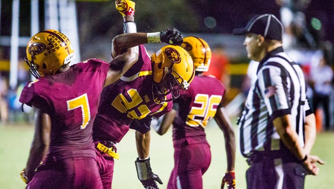 Mountain Pointe's Kenny Churchwell celebrates his interception with teammate Rashie Hodge during the second quarter against Chandler on Thursday, Sept. 8, 2016.