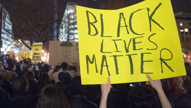 Thousands march in protest on Tuesday, Nov.  25, 2014, on the streets of Washington, DC,  one day after a grand jury decision not to prosecute a white police officer for the killing of an unarmed black teen in Ferguson, Mo.