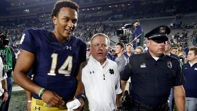 Oct 29, 2016; South Bend, IN, USA; Notre Dame Fighting Irish coach Brian Kelly walks off the field with Notre Dame Fighting Irish quarterback DeShone Kizer (14) at Notre Dame Stadium. Notre Dame defeats Miami 30-27. Mandatory Credit: Brian Spurlock-USA TODAY Sports